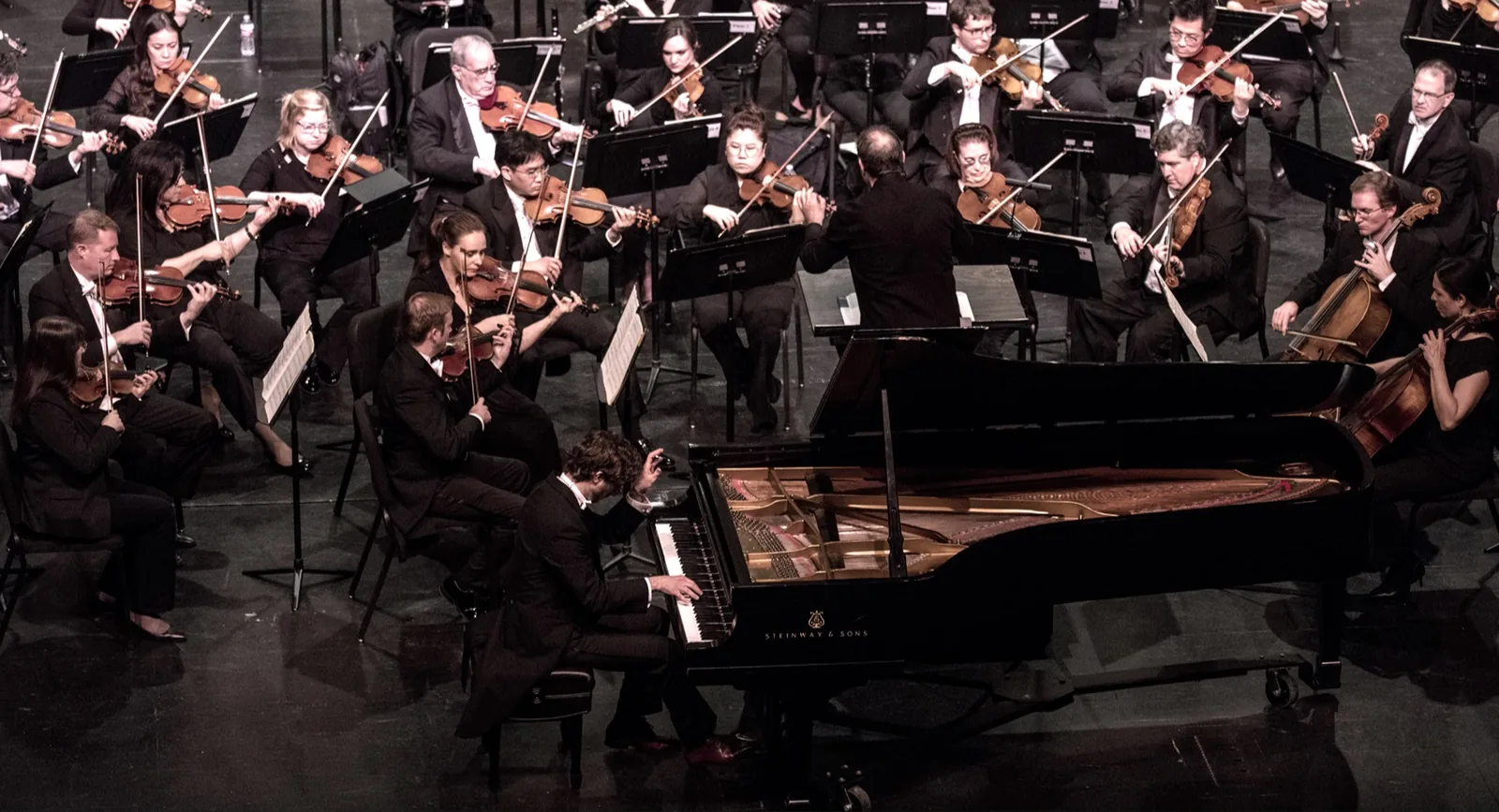 Luca Sacher al pianoforte con l'orchestra, durante un concerto